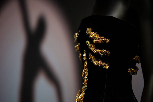 Black and gold dress worn by Dua Lipa at the 2024 Golden Globes designed by Daniel Roseberry for Schiaparelli is disp...