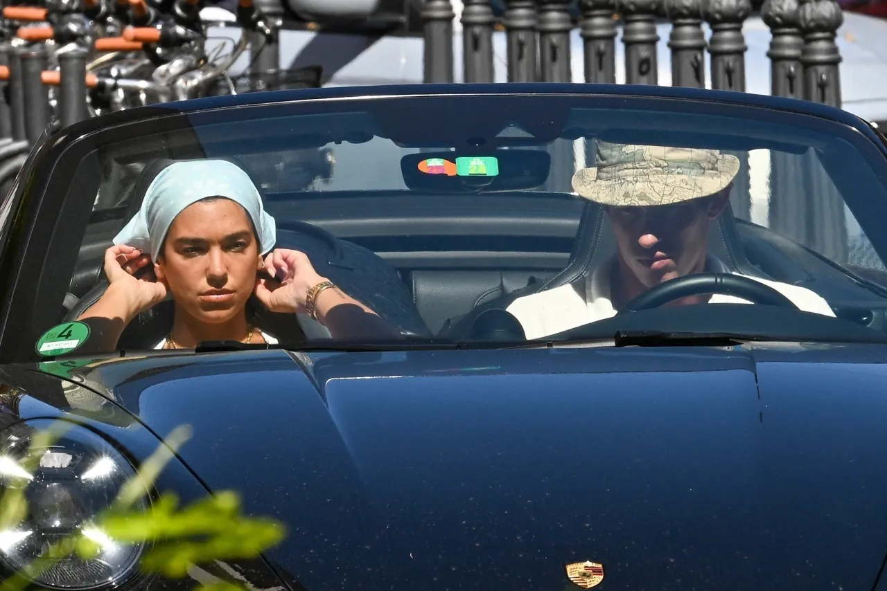 Dua Lipa and Callum Turner Leave Rome in Porsche
