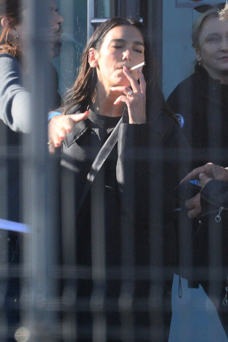 Dua Lipa at a Cigarette Break While Filming a Comm