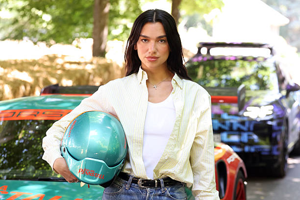 Dua Lipa at the Goodwood Festival of Speed, where she went up the world famous hillclimb today in the Dua Lipa Renstall Porsche 911 GT3 RS driven by Iron Dames racing driver Karen Gaillard at Goodwood Festival of Speed presented by Mastercard, which takes place in the parkland surrounding Goodwood House in West Sussex. Picture date: Saturday 12, 2025 — frame 2/5 (612×408)