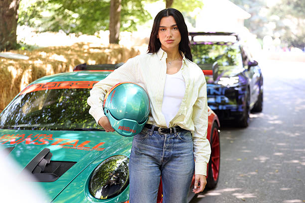 Dua Lipa at the Goodwood Festival of Speed, where she went up the world famous hillclimb today in the Dua Lipa Renstall Porsche 911 GT3 RS driven by Iron Dames racing driver Karen Gaillard at Goodwood Festival of Speed presented by Mastercard, which takes place in the parkland surrounding Goodwood House in West Sussex. Picture date: Saturday 12, 2025 — frame 4/5 (612×408)