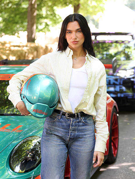 Dua Lipa at the Goodwood Festival of Speed, where she went up the world famous hillclimb today in the Dua Lipa Renstall Porsche 911 GT3 RS driven by Iron Dames racing driver Karen Gaillard at Goodwood Festival of Speed presented by Mastercard, which takes place in the parkland surrounding Goodwood House in West Sussex. Picture date: Saturday 12, 2025 — frame 1/5 (463×612)