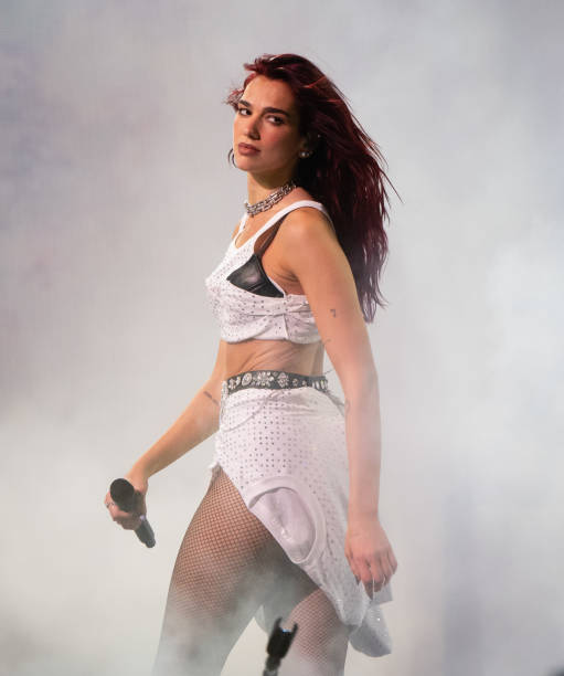 Dua Lipa performs as she headlines the Pyramid stage during day three of Glastonbury Festival 2024 at Worthy Farm, Pilton on June 28, 2024 in Glastonbury, England. Founded by Michael Eavis in 1970, Glastonbury Festival features around 3,000 performances across over 80 stages. Renowned for its vibrant atmosphere and iconic Pyramid Stage, the festival offers a diverse lineup of music and arts, embodying a spirit of community, creativity, and environmental consciousness (511×612)