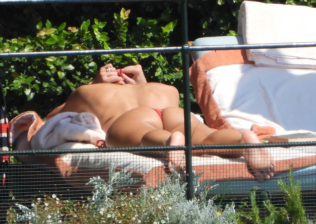 Dua Lipa Sunbathes Poolside in Bikini at her Frien
